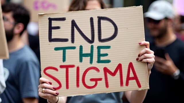 Protest Against Stigma: Advocates Hold Up Sign Calling for an End to Stigmatization at a Social Justice Rally in Urban Setting
