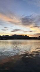 Tranquil Sunset Over a Serene Lake in Phuket with Soft Pastel Hues