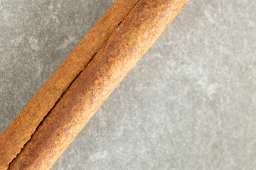close-up of cinnamon stick on grey background