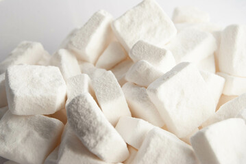 A detailed macro shot of white sugar cubes, showcasing their crystalline texture and sharp edges.