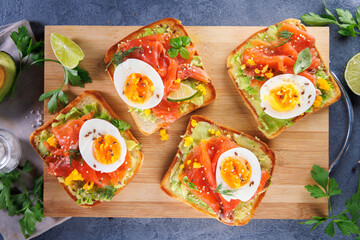 bread toast with salmon, avocado and egg