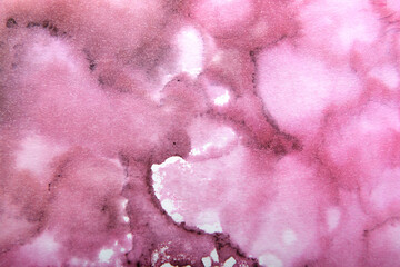 art background of ink stains on paper in crimson color