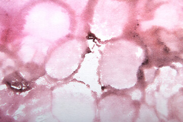 art background of ink stains on paper in crimson color