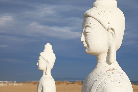 budas blancos estatuas en la arena de la playa de gand&iacute;a con chiringuito  4M0A7088-as25