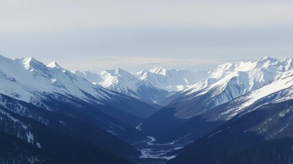 Fototapeta premium Snow-covered mountain peaks with a valley below, frozen lake, peaceful