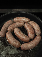 Sizzling bratwurst glistening with golden oil, nestled in cast iron skillet, representing rustic french alpine cuisine in chamonix