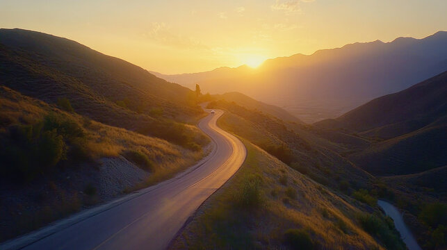 winding road through mountain range during stunning sunset, casting warm hues over landscape. serene scene captures beauty of nature and tranquility of moment - Powered by Adobe