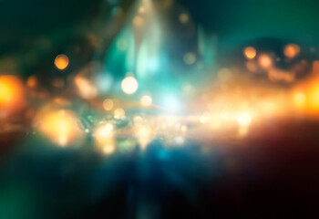 Abstract design with a grainy texture and a gradient of green, blue, yellow and orange.