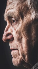 Obraz premium Elderly man's profile, thoughtful gaze, dark background, aging, healthcare