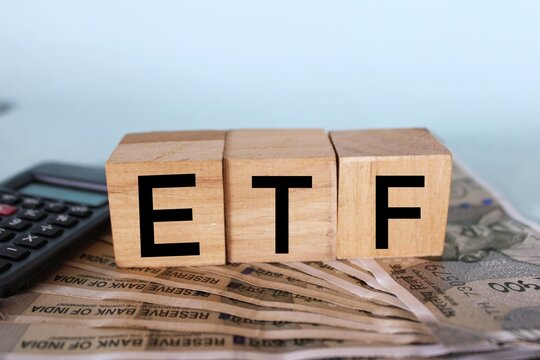 ETF Concept, ETFs Exchange Traded Funds on wooden blocks.