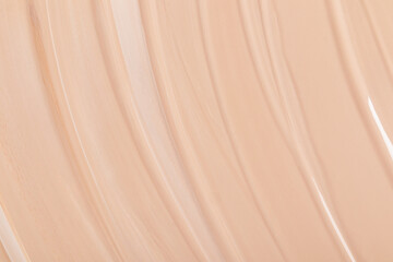 Abstract beige background of foundation liquid powder. Delicate matte texture of foundation. top view. A copy of space. Layout for cosmetics design.