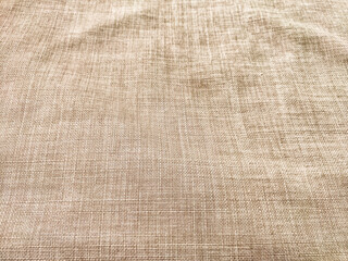 Neutral beige fabric background with subtle texture and pattern for versatile design applications and text placement