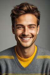 Fototapeta premium smiling man with a yellow sweater and grey sweater
