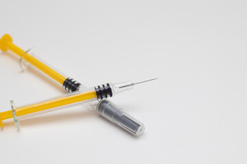 thin syringes for injection on white background