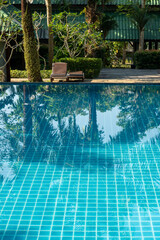Swimming pool and palm reflection in Thailand,  Southeast Asia.
