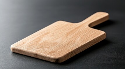 Fototapeta premium Wooden cutting board on dark surface, kitchen utensil