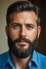 Fototapeta premium arafed man with a beard and blue shirt looking at the camera