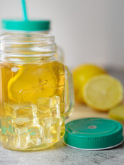 preparation of refreshing tea drink with lemon. fresh fruit