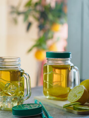 preparation of refreshing tea drink with lemon. fresh fruit