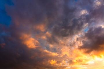 Sunset or sunrise sky. Dramatic clouds at sunset
