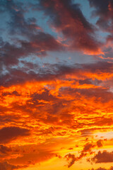 Vibrant orange clouds at sunset or sunrise. Sunset vertical photo