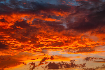 Dramatic clouds at sunset or sunrise. Orange clouds.