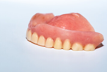 Old denture on a white background.