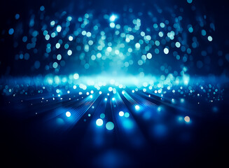 Obraz premium Abstract image of luminous blue bokeh lights and rays emanating from a central point on a dark blue backdrop, creating a dreamy and magical effect.