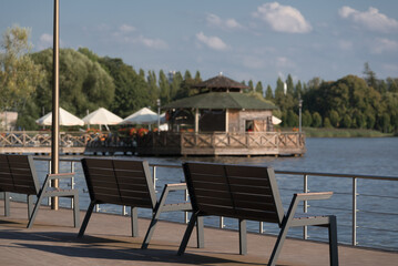LANDSCAPE BY LAKE - Wooden benches on the recreational and viewing platform of the Szczecinek city park
