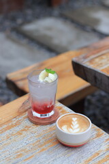 Refreshing Iced Drink and Latte Art Coffee Served on Rustic Wooden Table, Creates Cozy Cafe Vibes