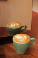 Two Cups of Coffee Reflect in a Mirror Smoothly and Elegantly with Latte Art