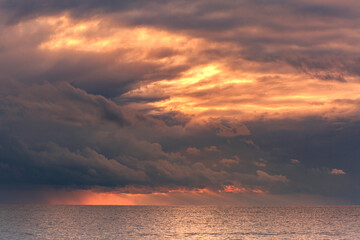 Orange clouds on the mediterranean sea at sunset, Turkey, Cirali, Antalya, sea.