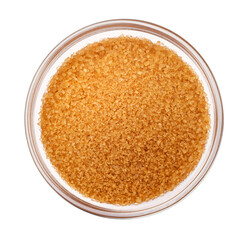 Brown cane sugar isolated on white background, top view