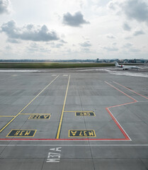 Fototapeta premium Empty airport apron near terminal - parking lot for airplanes. View of the empty apron from the second floor of airport terminal. 