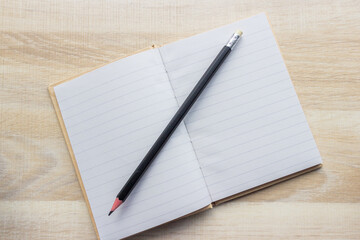 notebook and pen laying on a desk