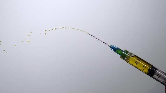 Expelling excess medicine from a hypodermic syringe. 2000fps slow motion