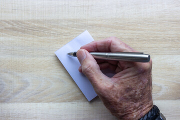 hand holding a pen ready to write