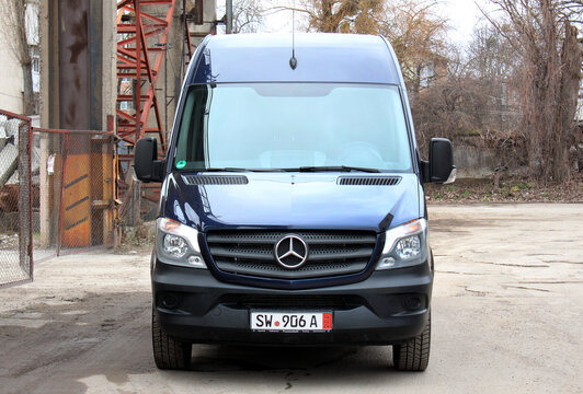 Vinnytsia, Ukraine; January 25, 2025. Blue Mercedes Sprinter 319 Cargo Van in construction site parking lot. Mercedes Sprinter  at city street. Cargo delivery by Mercedes Sprinter. Front view.