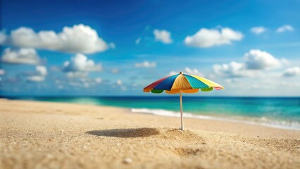 Miniature beach umbrella on a serene sandy shore, under a vibrant blue summer sky.