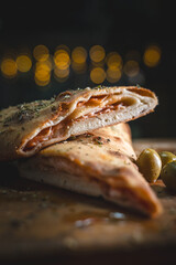 Mouthwatering cal zone cross-section with melted cheese oozing