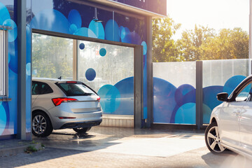 Automatic self-service tunnel car wash machine. Vehicle queue carwash station modern cleaning...