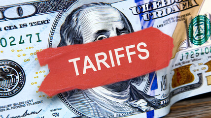 American Tariffs Label on a Hundred Dollar Bill, Bold 'TARIFFS' Text Overlaying U.S. Currency, Symbolic Representation of Economic Impact, High-Resolution Detail on Bill's Design, Financial and Trade 