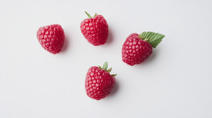 Fresh red raspberries and green leaves on white background for food styling, summer recipes, and healthy lifestyle concepts