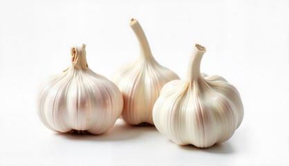 Obraz premium Trio of garlic bulbs with smooth and textured skin on a white background with copy space