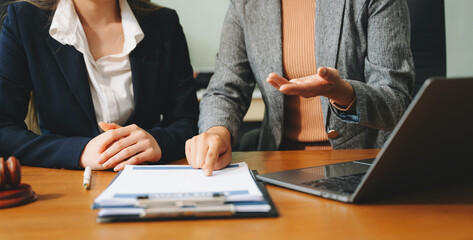 Business people compassionately holding hands and discussing contract papers