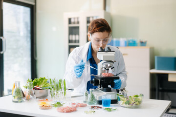Scientist in a modern lab analyzing food samples with advanced equipment. Perfect for food science, research