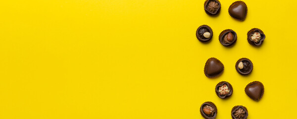 Different kinds of chocolates on colored table close-up. Top View and Flat Lay with copy space