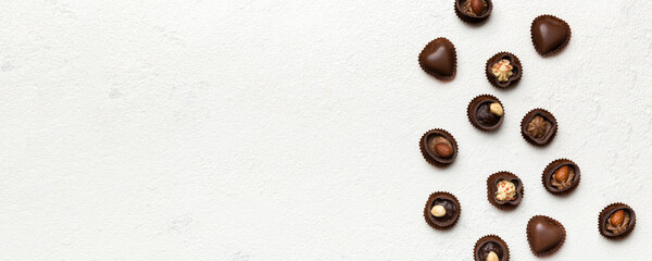 Different kinds of chocolates on colored table close-up. Top View and Flat Lay with copy space