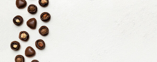 Different kinds of chocolates on colored table close-up. Top View and Flat Lay with copy space