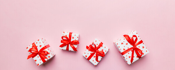 Valentine day composition: red gift box with bow and heart. Christmas present. View from above....